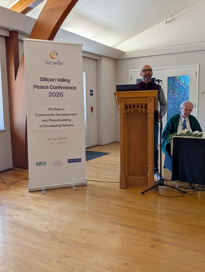 Gaurav Rastogi speaking at the lectern, presenting Deus Et Machina, Silicon Valley Peace Conference 2026, Palo Alto